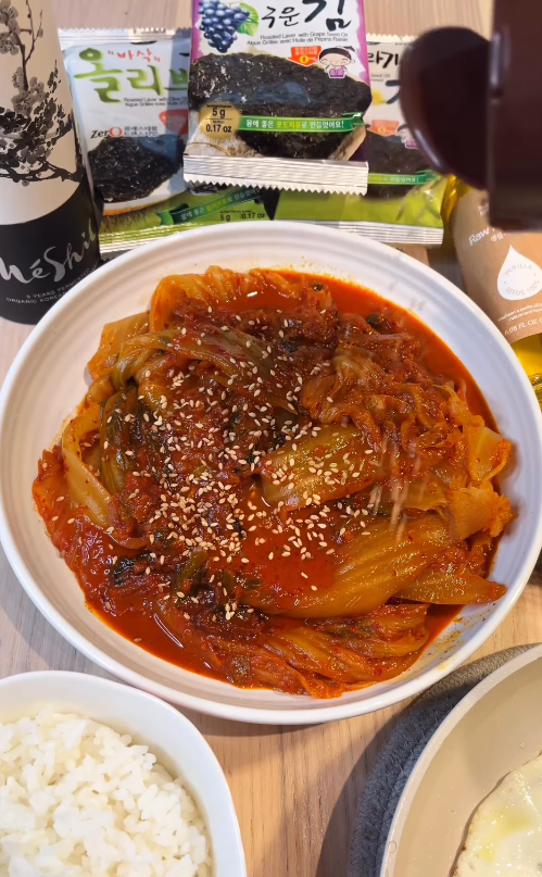 Tender braised kimchi cooked with perilla oil and Korean plum extract, served with rice, gim, and eggs.