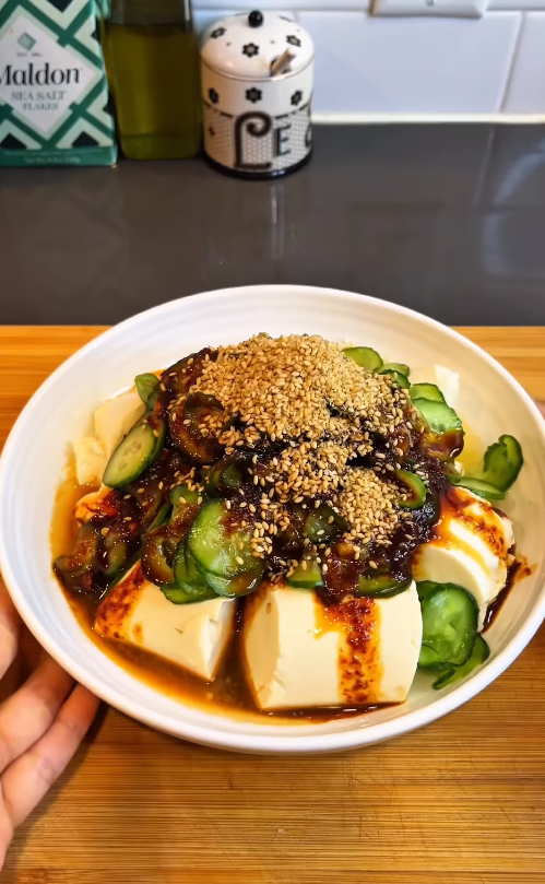 Cucumber soft tofu salad topped with freshly ground roasted sesame seeds and a savory Korean dressing.